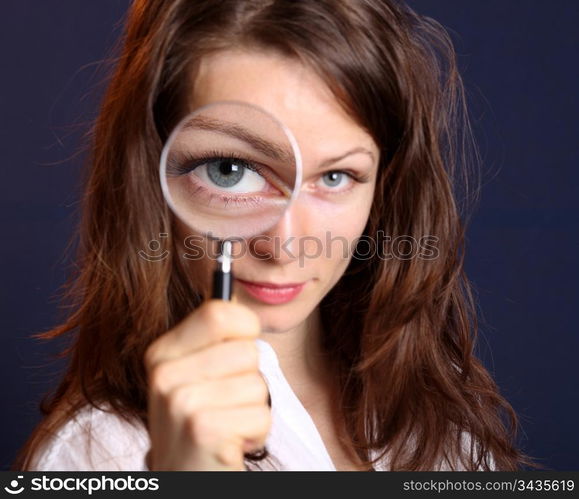 Cute woman with magnifying glass