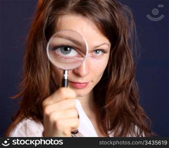 Cute woman with magnifying glass
