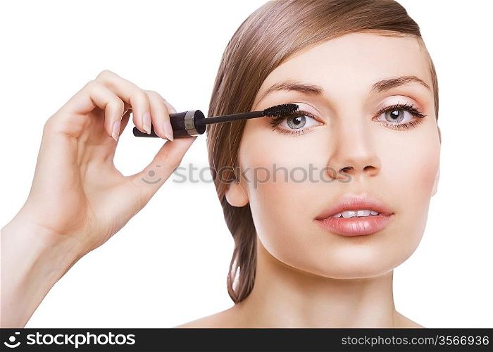 cute woman with mascara brush on white background