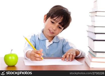 Cute young boy busy in drawing with pile of books beside him