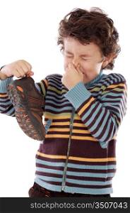 Cute young boy with stinky shoe pitching his nose