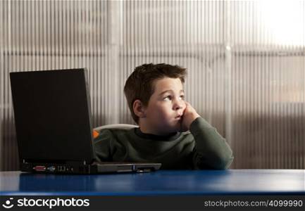 Cute young boy working on a laptop computer