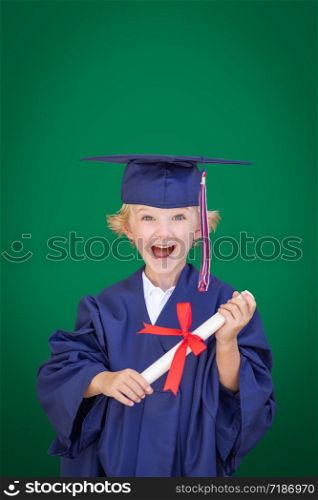 Cute Young Caucasian Boy Wearing Graduation Cap and Gown Against Blank Green Background.
