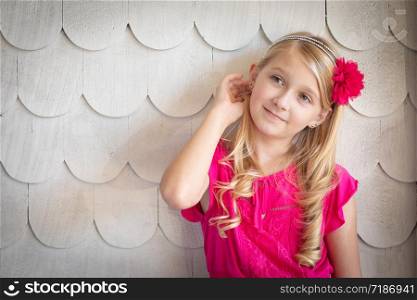 Cute Young Caucasian Girl Portrait Against A Wall.
