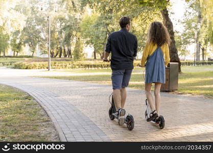 cute young couple riding scooter outdoors