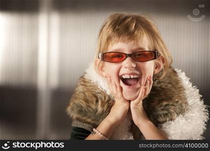 Cute young girl in dress-up clothes and red sunglasses