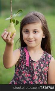 Cute young girl taking a pear from a branch - focus in the face _