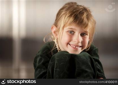 Cute young girl with big eyes in dress-up clothes
