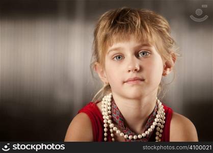 Cute young girl with big eyes in dress-up clothes