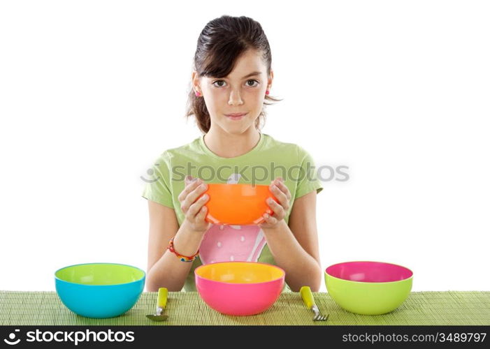 Cute young girl with empty colourful bowls