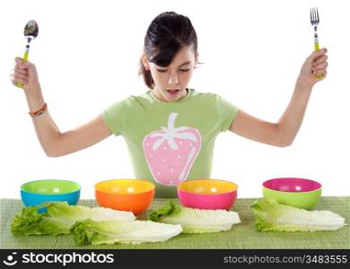 Cute young girl with lettuce and colourful bowls