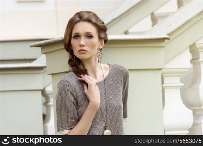 cute young girl with lovely elegant style and braid hairdo posing in outdoor fashion portrait
