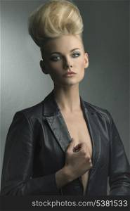 cute young girl with rock creative hair-style and leather jacket posing in cute fashion shoot