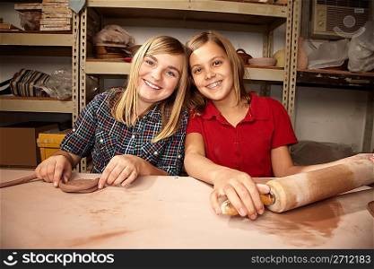 Cute young girls in a clay studio
