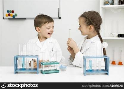 cute young kids scientists with test tubes