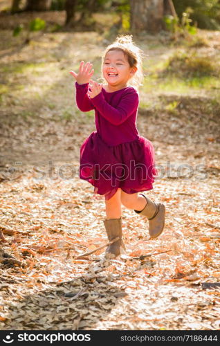 Cute Young Mixed Race Baby Girl Playing Outdoors.