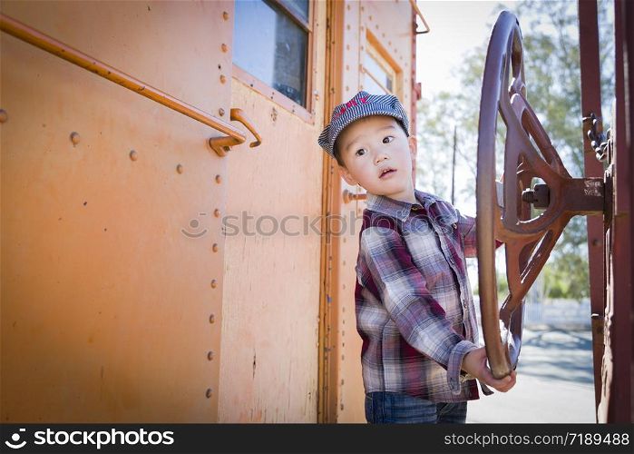 Cute Young Mixed Race Boy Having Fun Outside on Railroad Car.