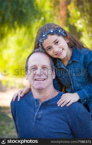 Cute Young Mixed Race Girl And Caucasian Grandfather Having Fun Outdoors.