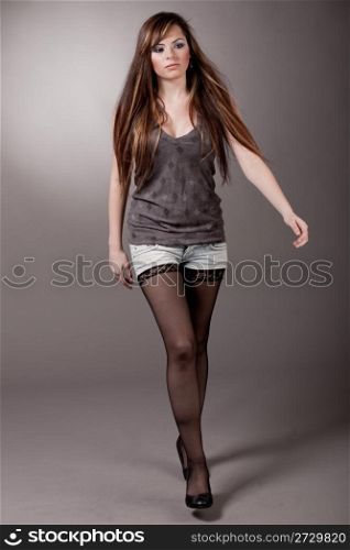 Cute young model walking, indoor studio