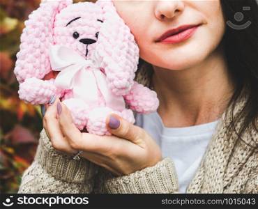Cute young woman holding a stuffed toy in her hands. Cute young woman holding a stuffed toy