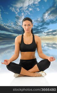 cute young woman isolated on white in classic yoga meditation pose