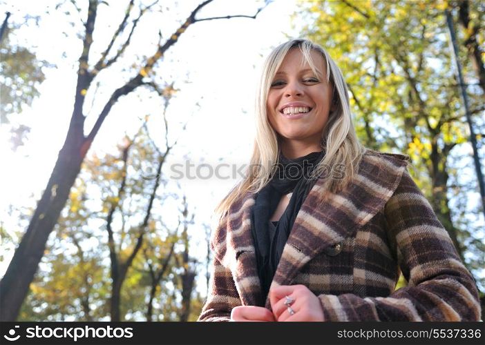 Cute young woman smiling outdoors in nature