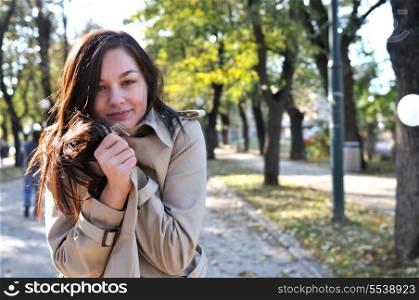 Cute young woman smiling outdoors in nature