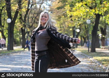 Cute young woman smiling outdoors in nature