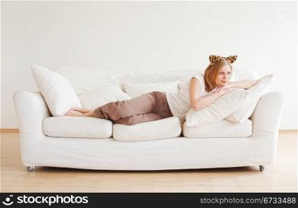 cute young woman with neko ears dreaming on couch
