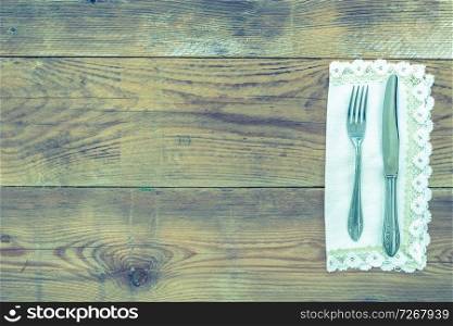 Cutlery and napkin on wooden background.. Cutlery on wood
