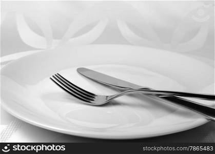 Cutlery knife and fork on a plate