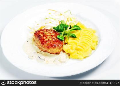 Cutlet in sauce with potato and vegetables