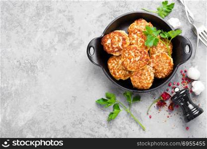 Cutlets. Fried cutlets in cast-iron pan on table