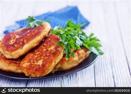 cutlets on black plate and on a table