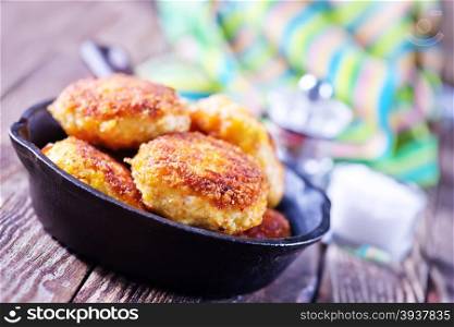 cutlets on pan and on a table