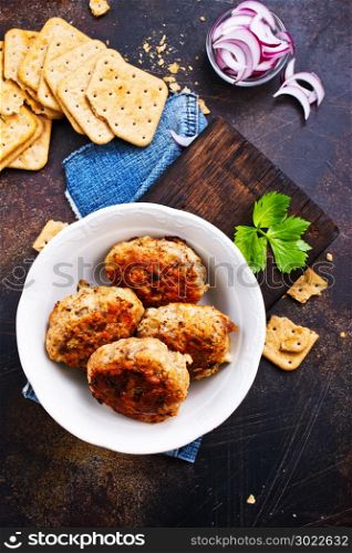 cutlets on white plate and on a table, chicken cutlets