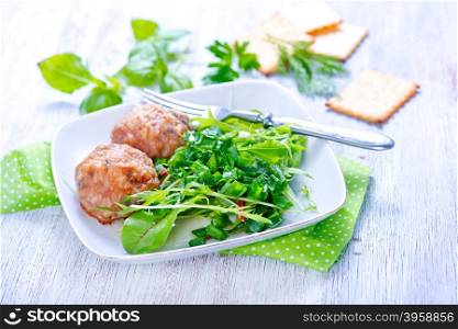cutlets with salad on plate and on a table