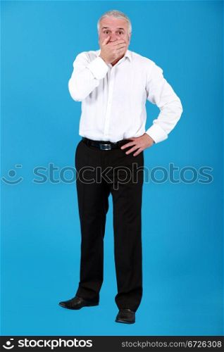 Cutout businessman with his hand over his mouth