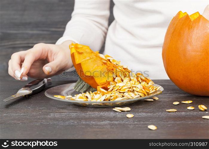 Cutting a pumpkin while preparing for the celebration of Halloween. Cutting a pumpkin