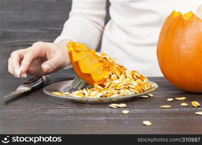 Cutting a pumpkin while preparing for the celebration of Halloween. Cutting a pumpkin