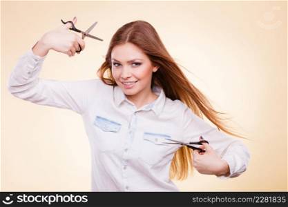 Cutting as a way of healthy strong hair. Girl barber with scissors ready to trimming. Female stylist holds trimmers prepared to haircut.. Female barber with trimmers scissors.