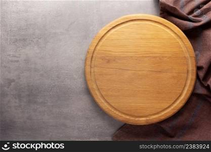 Cutting board and napkin tablecloth at stone background top table. Wooden pizza board