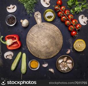 cutting board, around lie ingredients variety of vegetables and fruits, place for text,frame on wooden rustic background top view