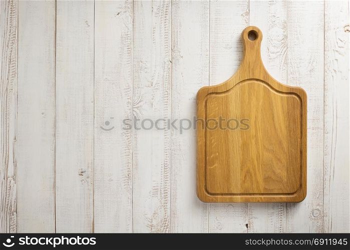 cutting board at white plank wooden background texture
