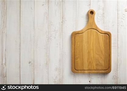 cutting board at white plank wooden background texture