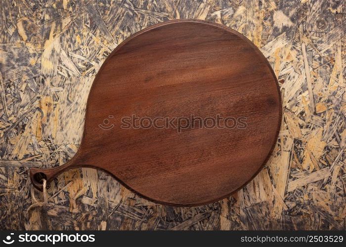 Cutting board at wood background top table. Wooden pizza board