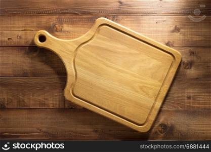 cutting board at wooden plank background
