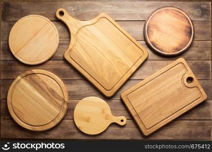 cutting board at wooden plank table board background, top view