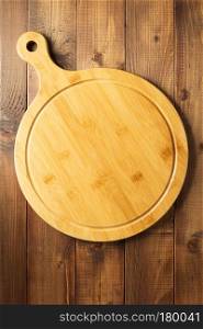 cutting board at wooden table surface, top view