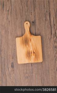 Cutting board on wooden background.